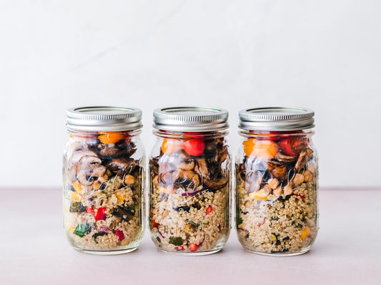 Three glass mason jars with metal screw lids on a kitchen surface